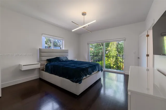 a spacious bedroom with a bed and a window