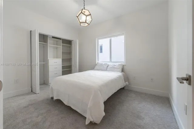 a spacious bedroom with a bed and a window