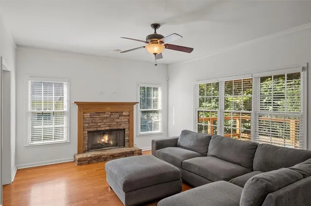 a living room with furniture a window and a fireplace