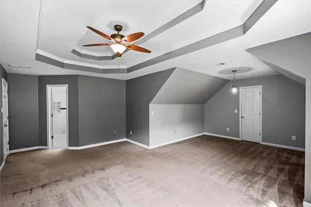 a view of an empty room with a ceiling fan