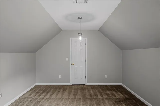 a view of a hallway with a chandelier fan
