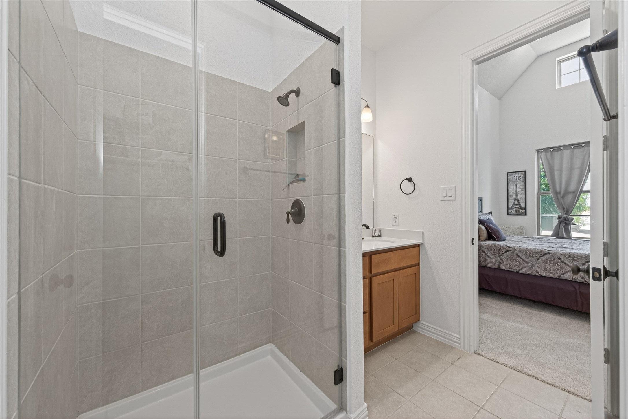20802 Mirror Point Drive Cypress, TX 77433 - Photo 25 of 37 The bathroom boasts a spacious glass shower, attractive tile work, and well-appointed sink and cabinetry. This description emphasizes the key attractive features of the bathroom, including the modern glass shower, appealing tile design, and the quality of the fixtures and storage.