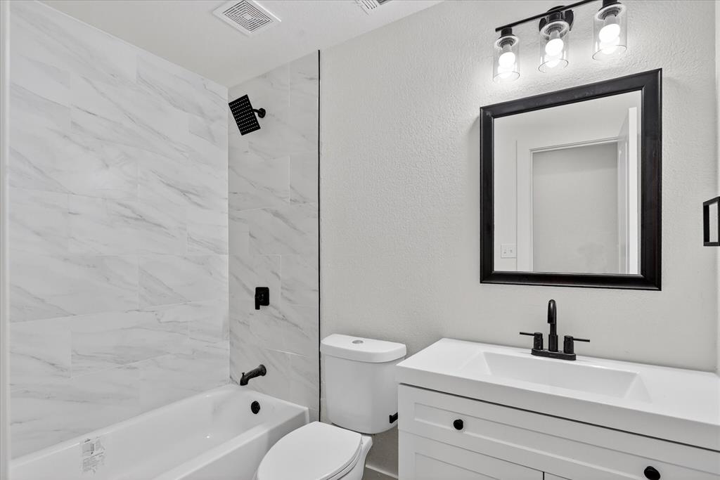 6021 Hartman Road Forest Hill, TX 76119 - Photo 21 of 27 a bathroom with a sink a toilet and shower