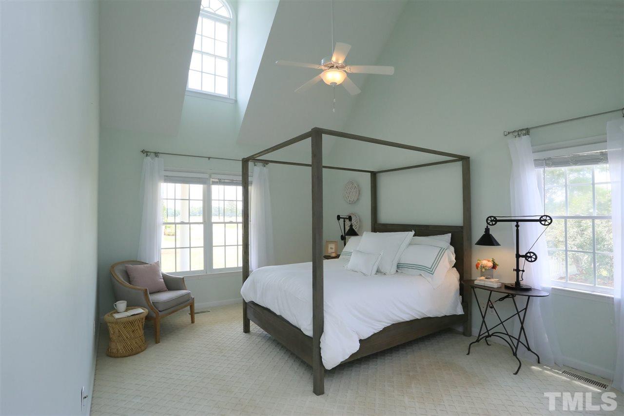 2001 Edgemont Road Wendell, NC 27591 - Photo 16 of 30 a bedroom with a bed and a chandelier