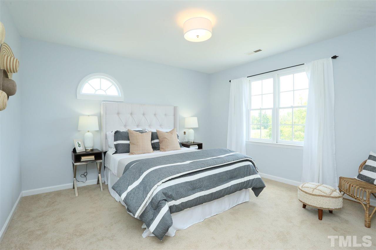 2001 Edgemont Road Wendell, NC 27591 - Photo 17 of 30 a bedroom with a bed and window
