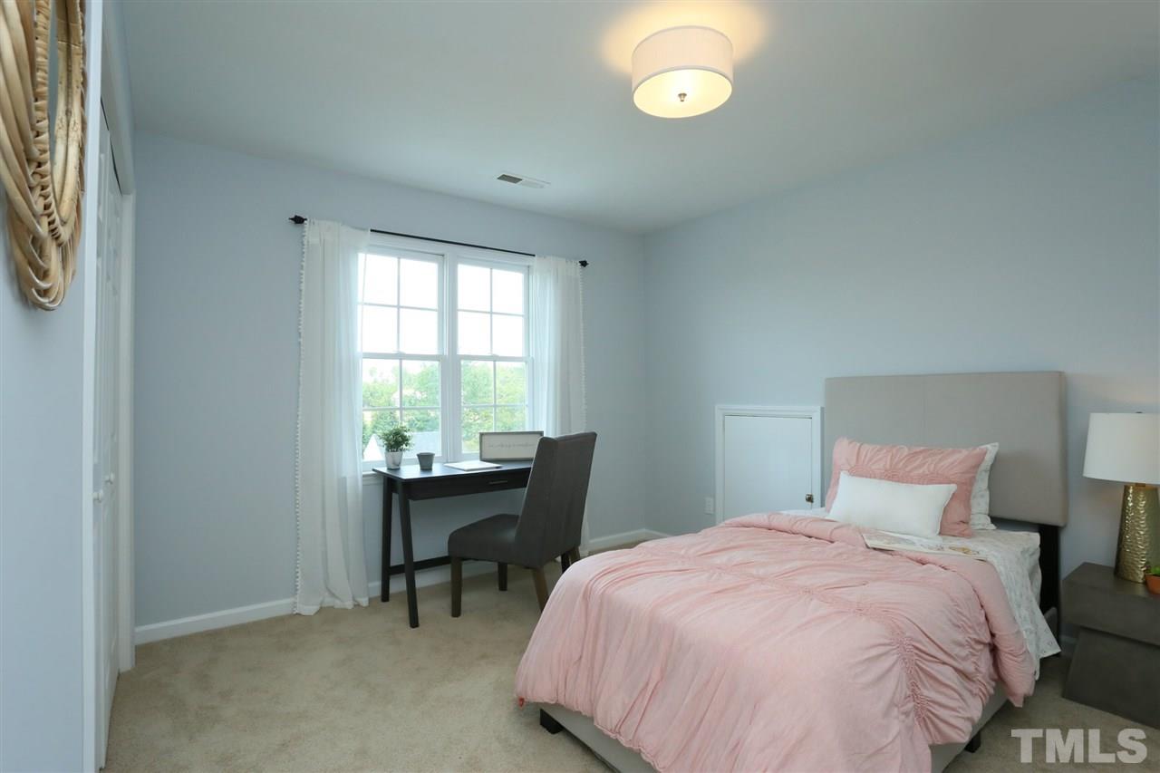 2001 Edgemont Road Wendell, NC 27591 - Photo 19 of 30 a bedroom with a bed and a table next to a window