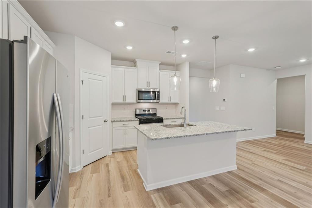 7204 Ensemble Court Fairburn, GA 30213 - Photo 16 of 56 a kitchen with stainless steel appliances granite countertop a refrigerator and a sink