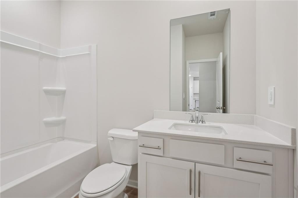 7204 Ensemble Court Fairburn, GA 30213 - Photo 25 of 56 a bathroom with a sink toilet vanity and tub