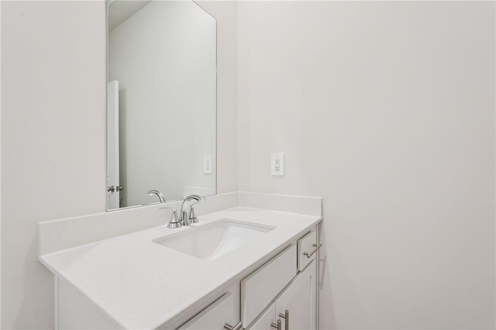 7204 Ensemble Court Fairburn, GA 30213 - Photo 27 of 56 a bathroom with a sink and a mirror