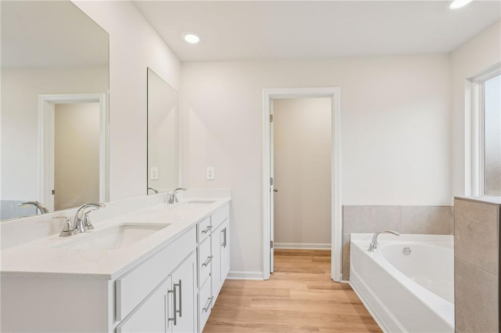 7204 Ensemble Court Fairburn, GA 30213 - Photo 33 of 56 a spacious bathroom with a tub sink and mirror
