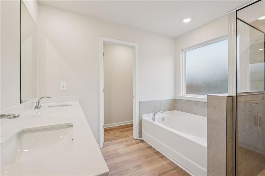 7204 Ensemble Court Fairburn, GA 30213 - Photo 35 of 56 a white bath tub sitting next to a white sink