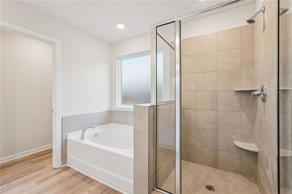 7204 Ensemble Court Fairburn, GA 30213 - Photo 36 of 56 a bathroom with a bathtub and a shower