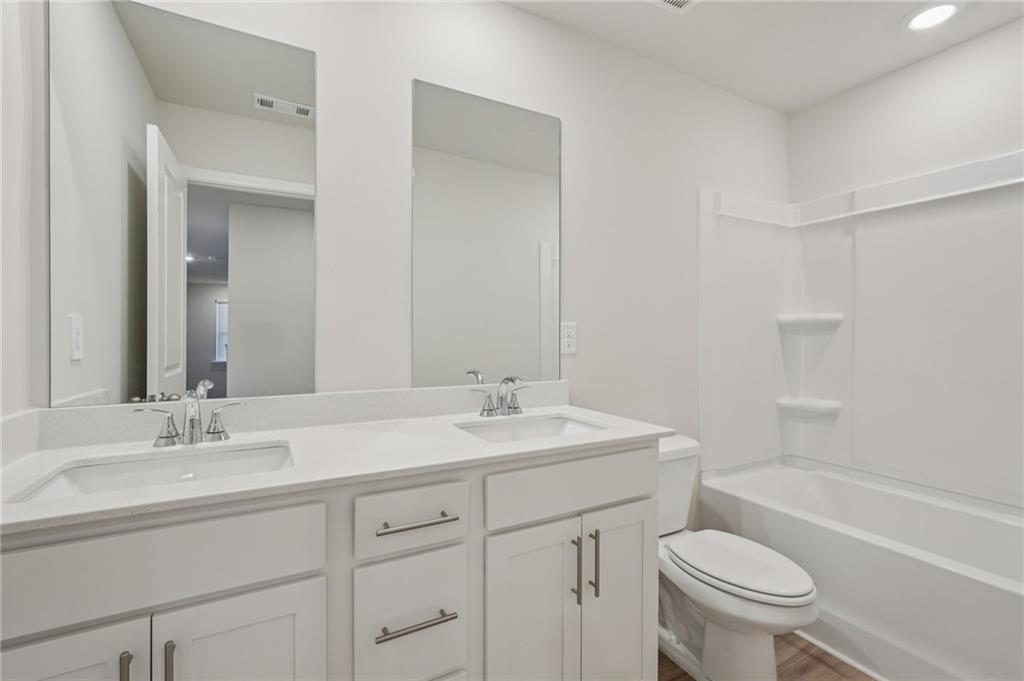 7204 Ensemble Court Fairburn, GA 30213 - Photo 46 of 56 a bathroom with a sink a toilet and a bathtub