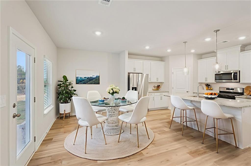 7204 Ensemble Court Fairburn, GA 30213 - Photo 6 of 56 a view of a dining room with furniture
