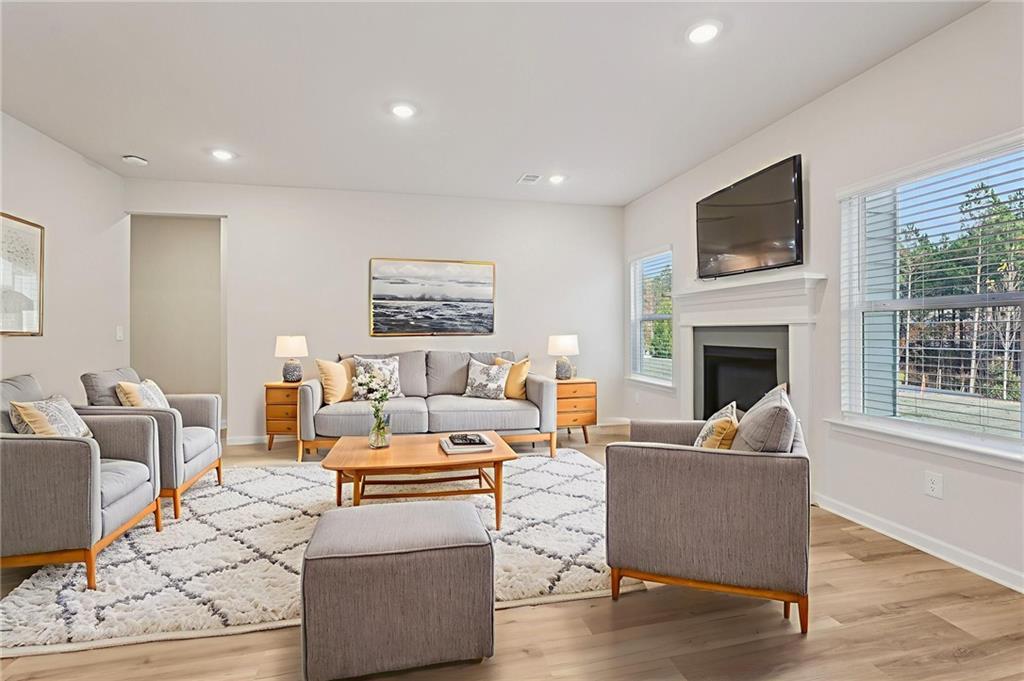 7204 Ensemble Court Fairburn, GA 30213 - Photo 9 of 56 a living room with fireplace furniture and a flat screen tv