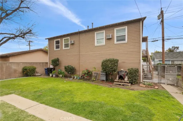 a backyard of a house with table and chairs