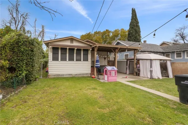 a view of a house with a backyard and porch