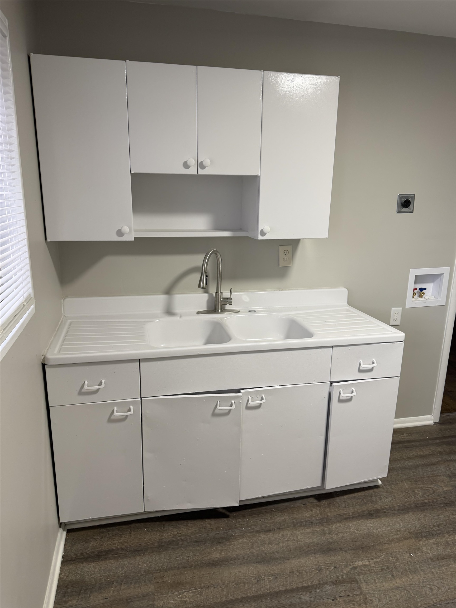 194 East Biscayne Road Memphis, TN 38109 - Photo 2 of 6 a kitchen with a sink cabinets and wooden floor