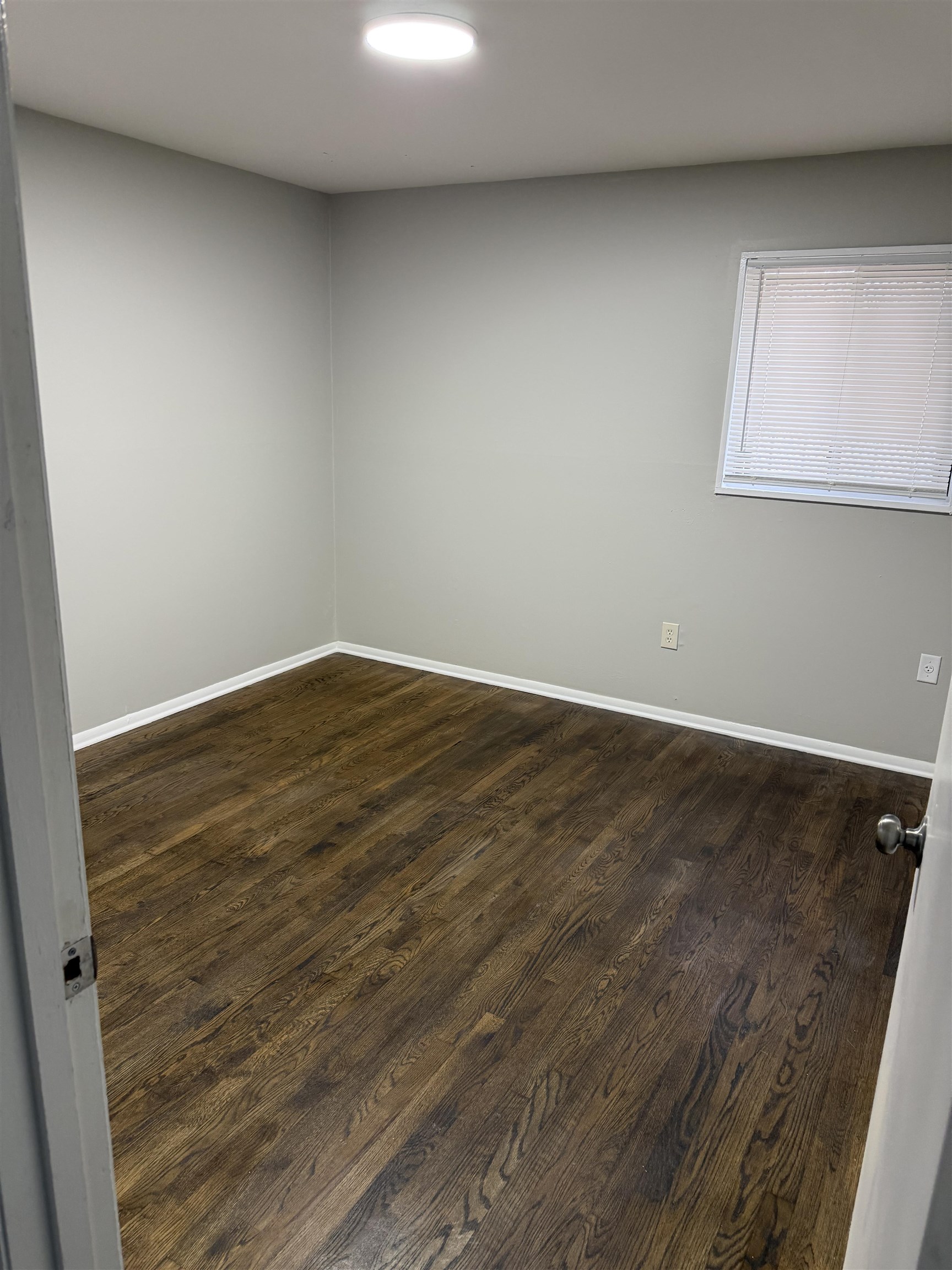 194 East Biscayne Road Memphis, TN 38109 - Photo 6 of 6 an empty room with wooden floor and windows