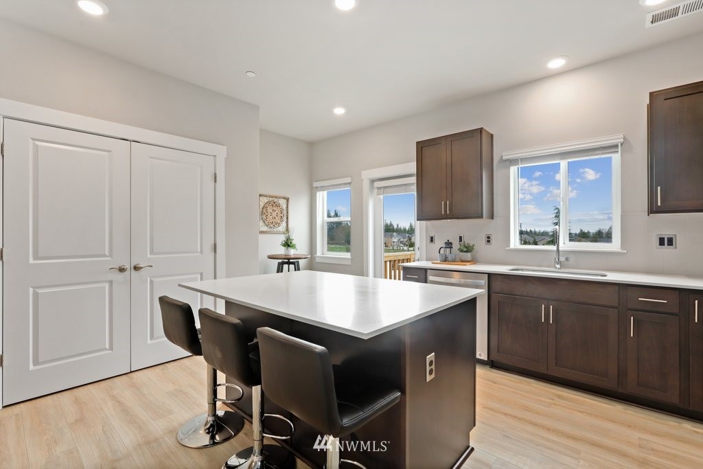 1621 Seattle Hill Road, Unit Z2 Bothell, WA 98012 - Photo 11 of 35 a kitchen with a sink chairs and cabinets