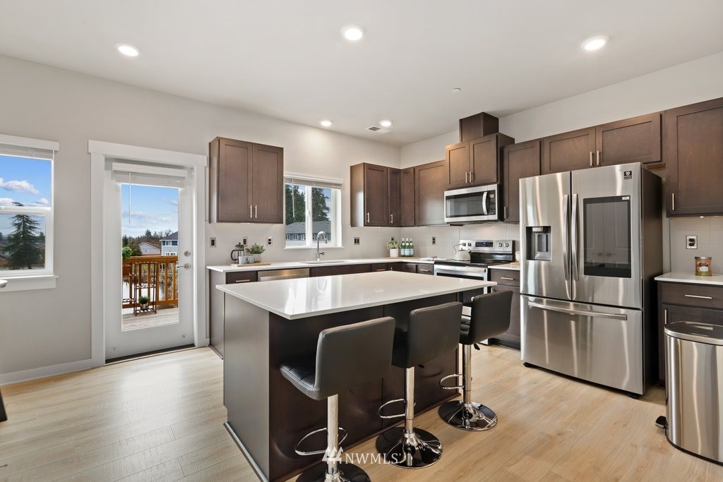 1621 Seattle Hill Road, Unit Z2 Bothell, WA 98012 - Photo 7 of 35 a kitchen with kitchen island granite countertop stainless steel appliances a sink and counter space