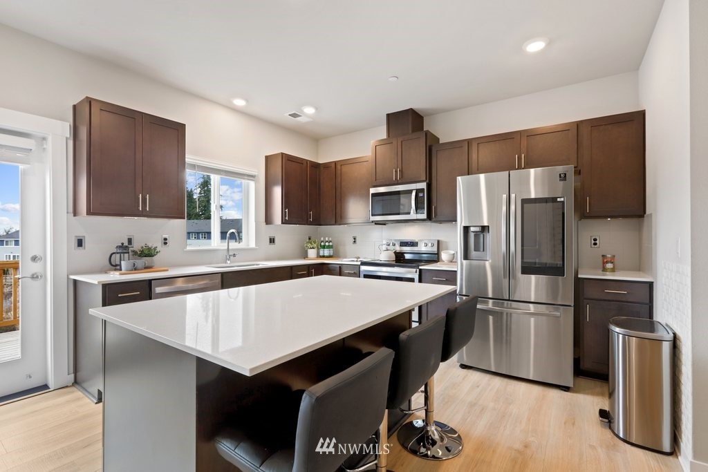 1621 Seattle Hill Road, Unit Z2 Bothell, WA 98012 - Photo 8 of 35 a kitchen with kitchen island a sink appliances and cabinets
