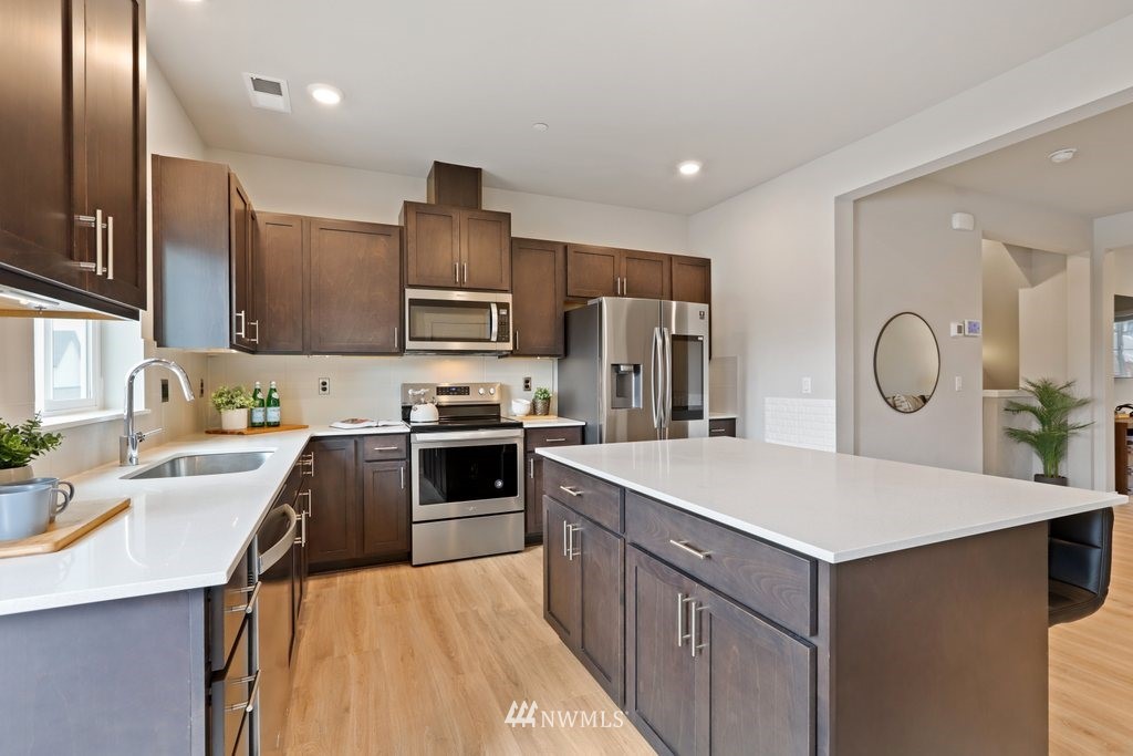 1621 Seattle Hill Road, Unit Z2 Bothell, WA 98012 - Photo 9 of 35 a kitchen that has a sink stainless steel appliances a refrigerator and a center island