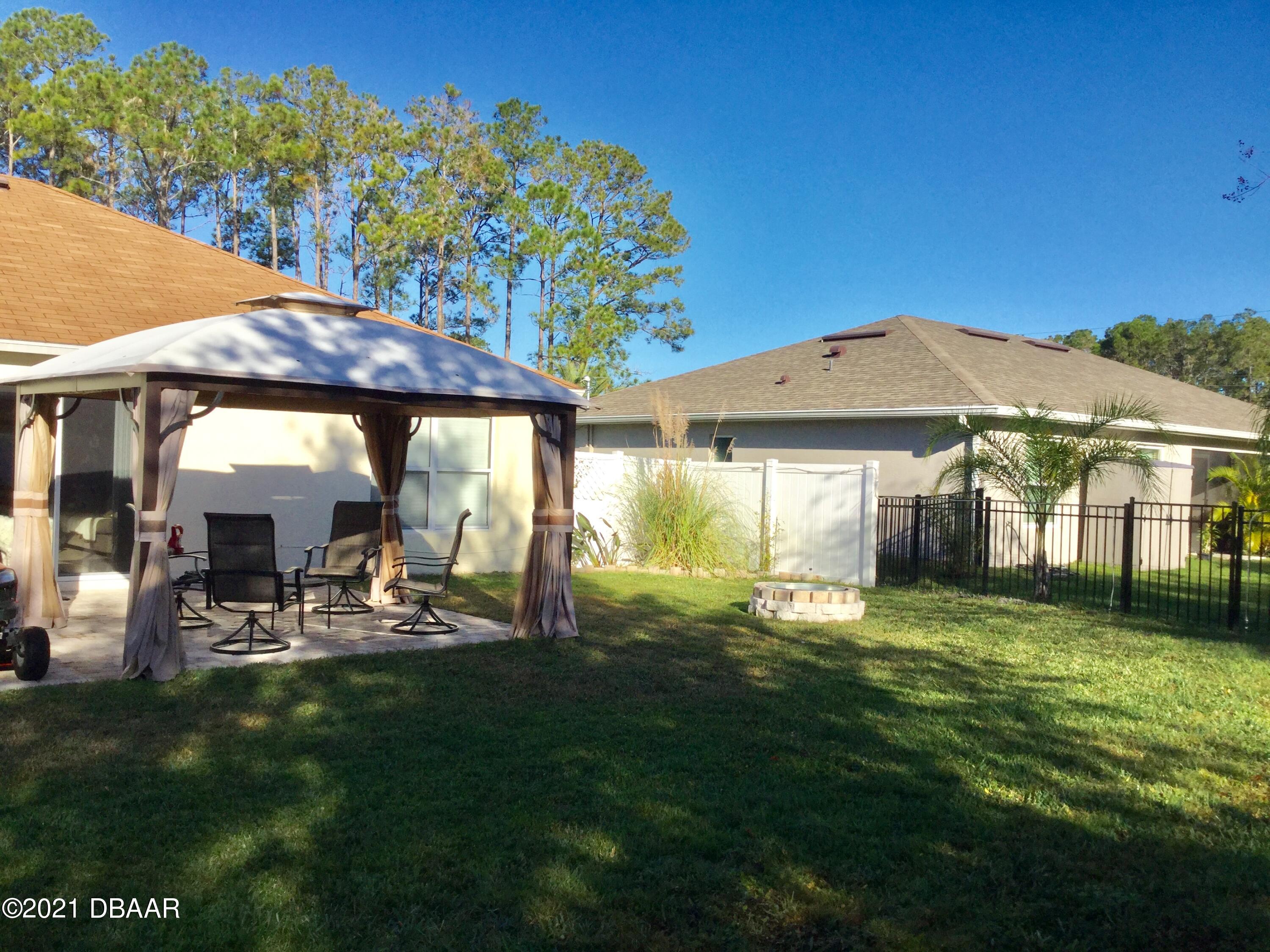 40 Riverside Lane Palm Coast, FL 32164 - Photo 11 of 47 a view of a chair and table in backyard of the house