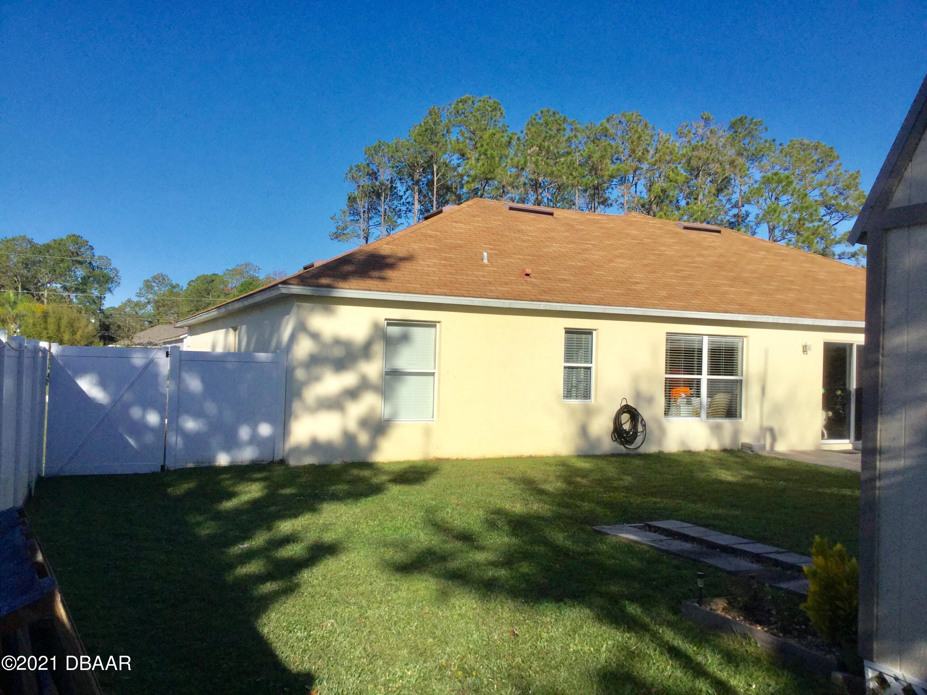 40 Riverside Lane Palm Coast, FL 32164 - Photo 14 of 47 a view of a house with a yard