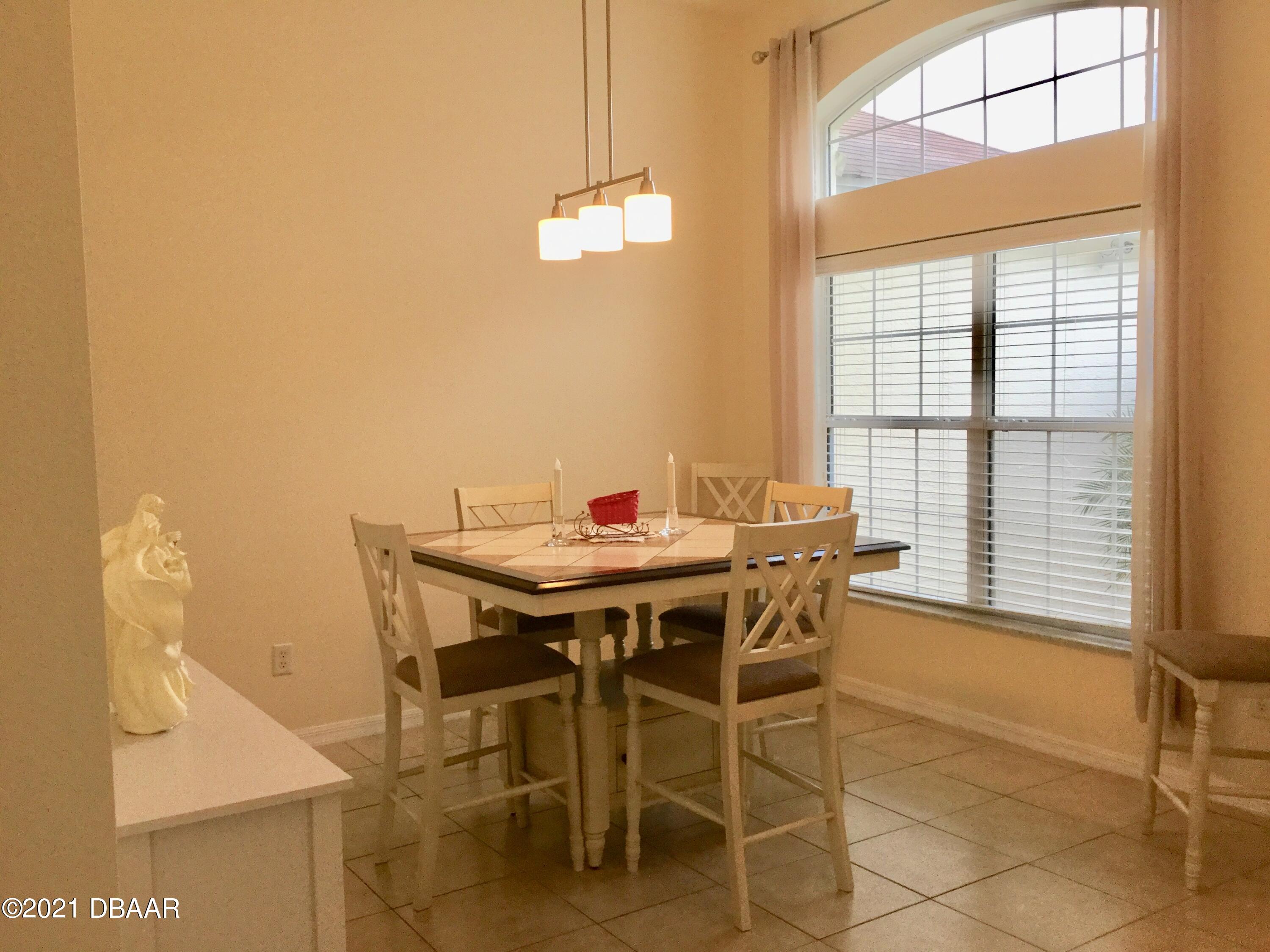 40 Riverside Lane Palm Coast, FL 32164 - Photo 20 of 47 a view of a dining room with furniture and window