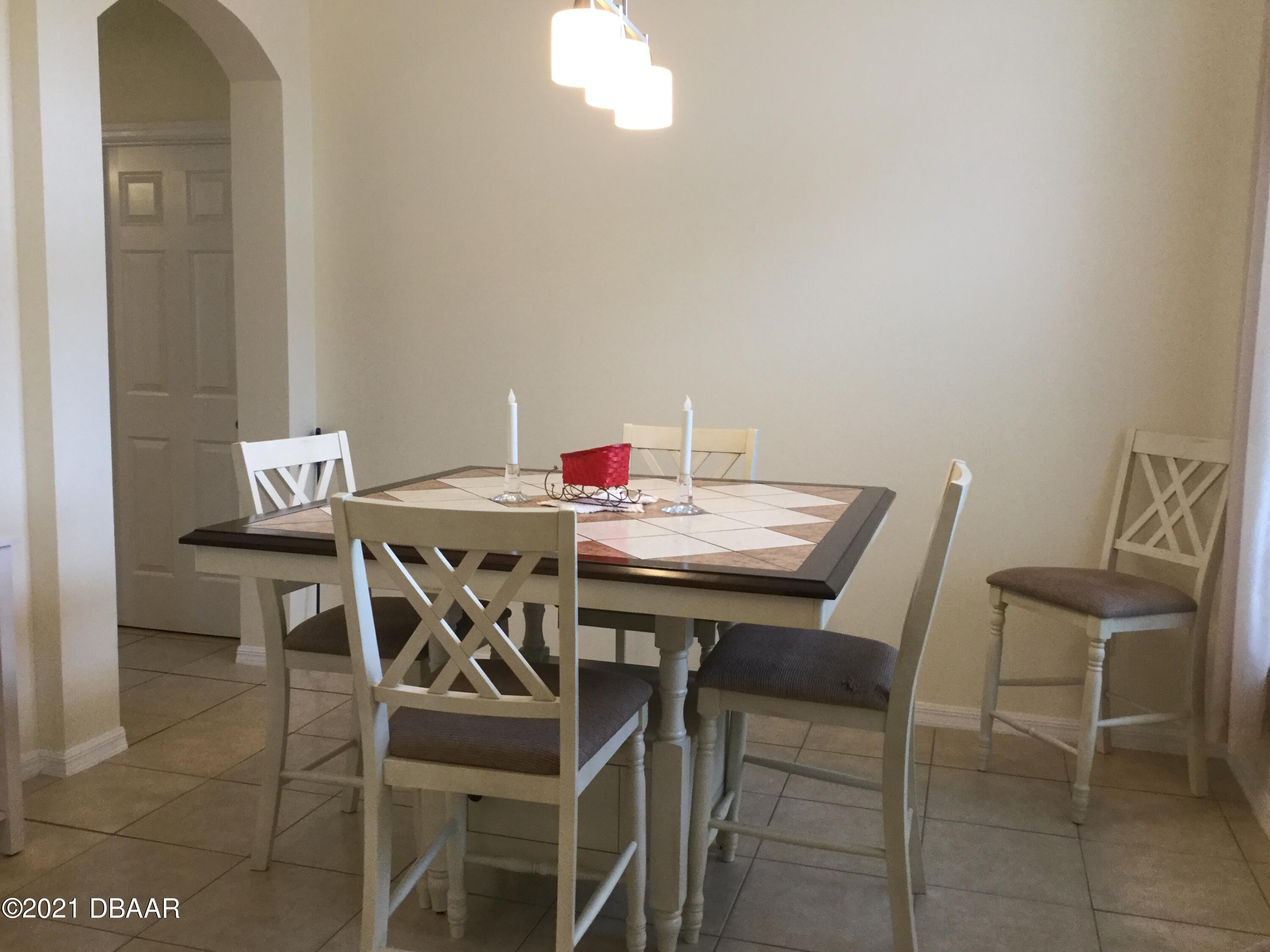 40 Riverside Lane Palm Coast, FL 32164 - Photo 21 of 47 a view of a dining room with furniture and chandelier