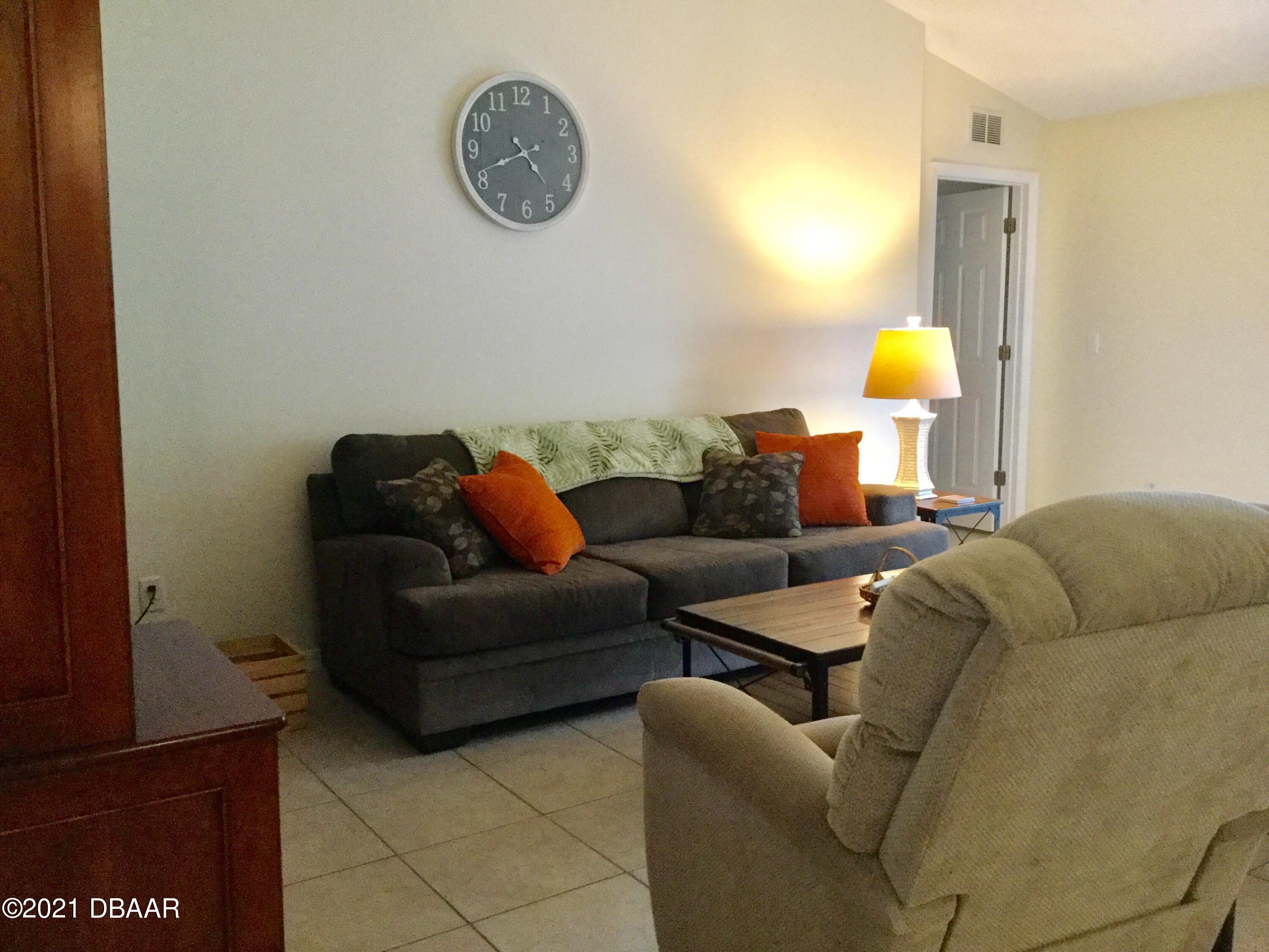 40 Riverside Lane Palm Coast, FL 32164 - Photo 22 of 47 a living room with furniture and a window