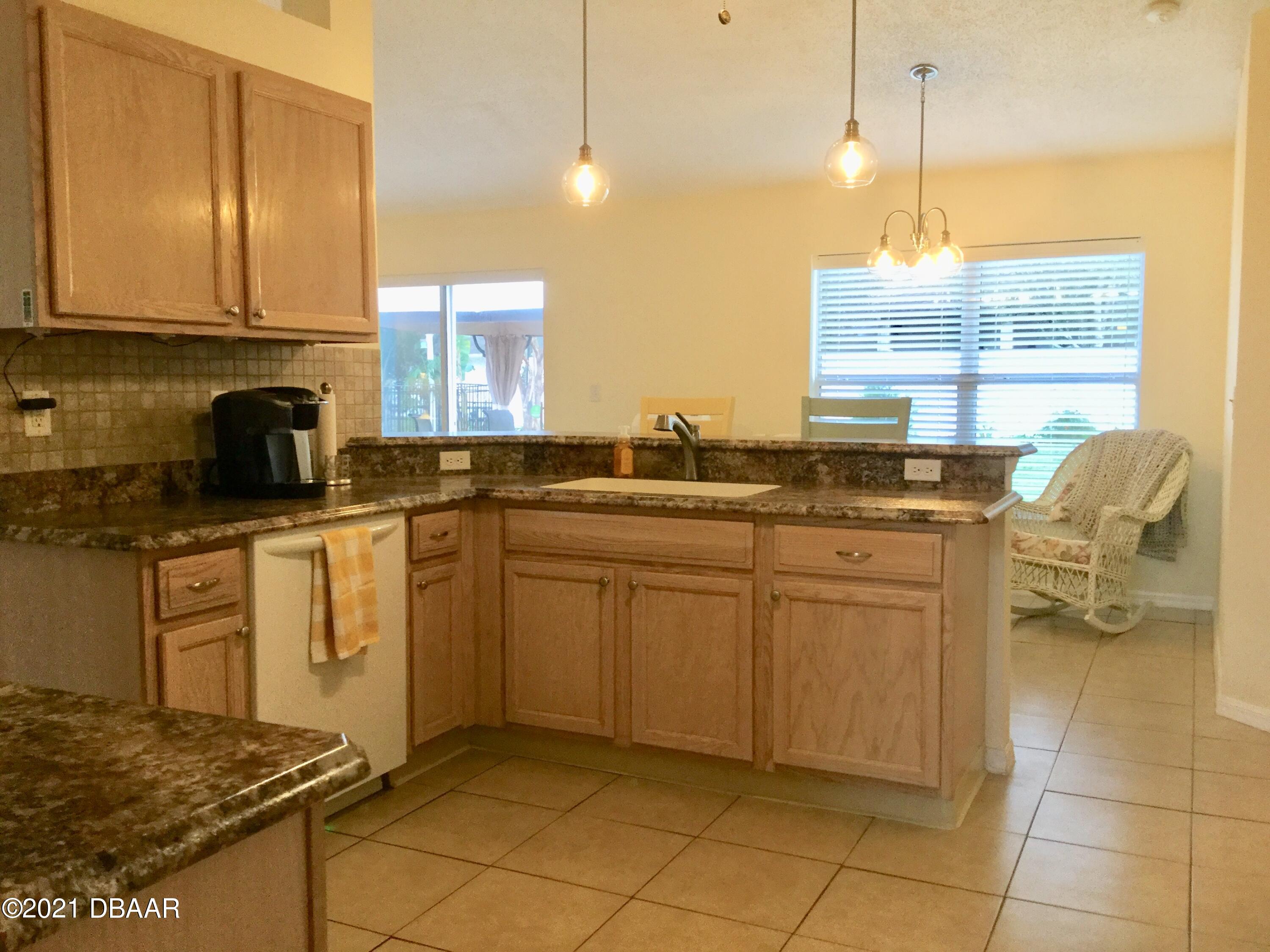40 Riverside Lane Palm Coast, FL 32164 - Photo 28 of 47 a kitchen with cabinets and window