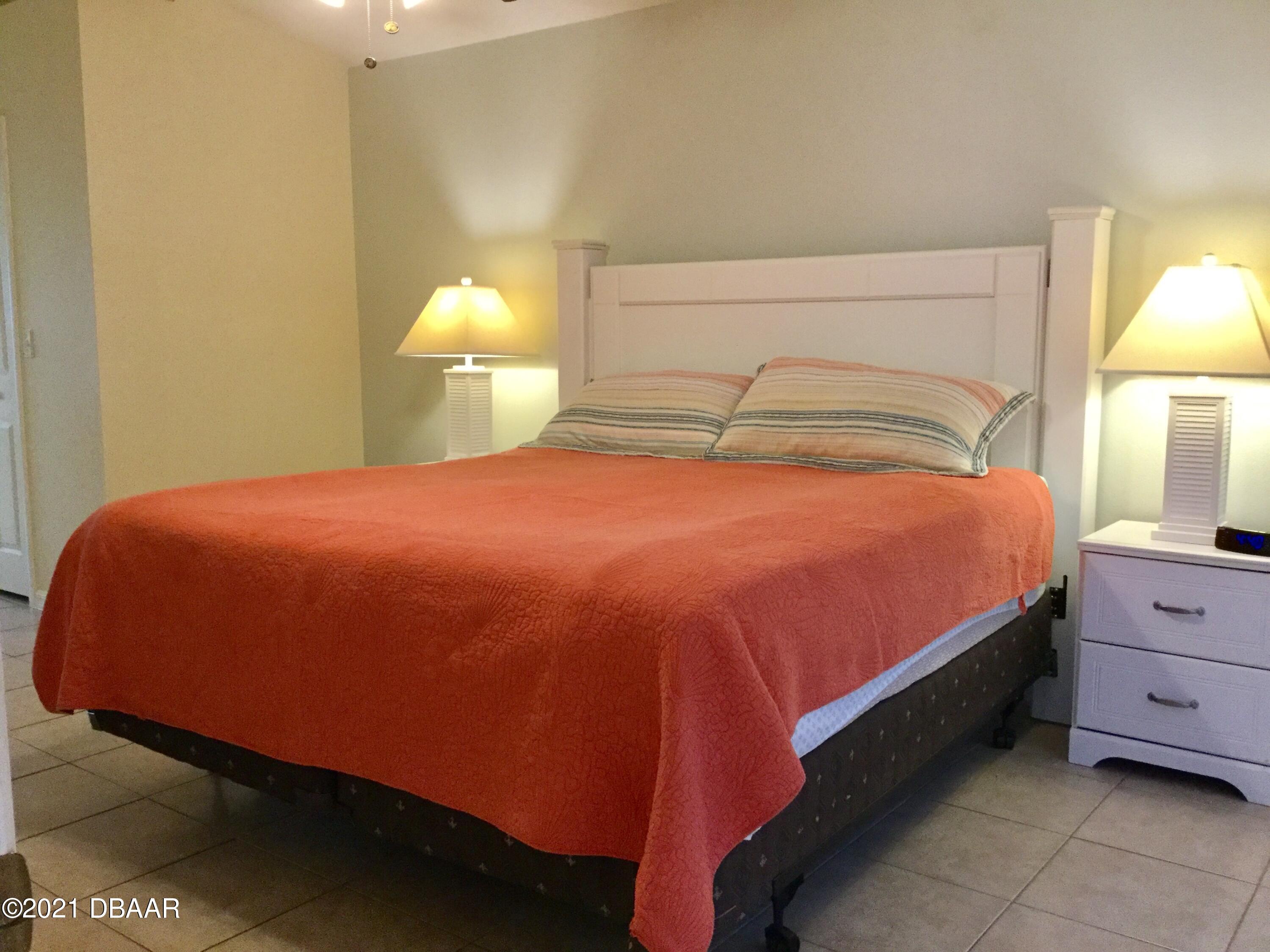 40 Riverside Lane Palm Coast, FL 32164 - Photo 36 of 47 a bedroom with a bed and a lamp