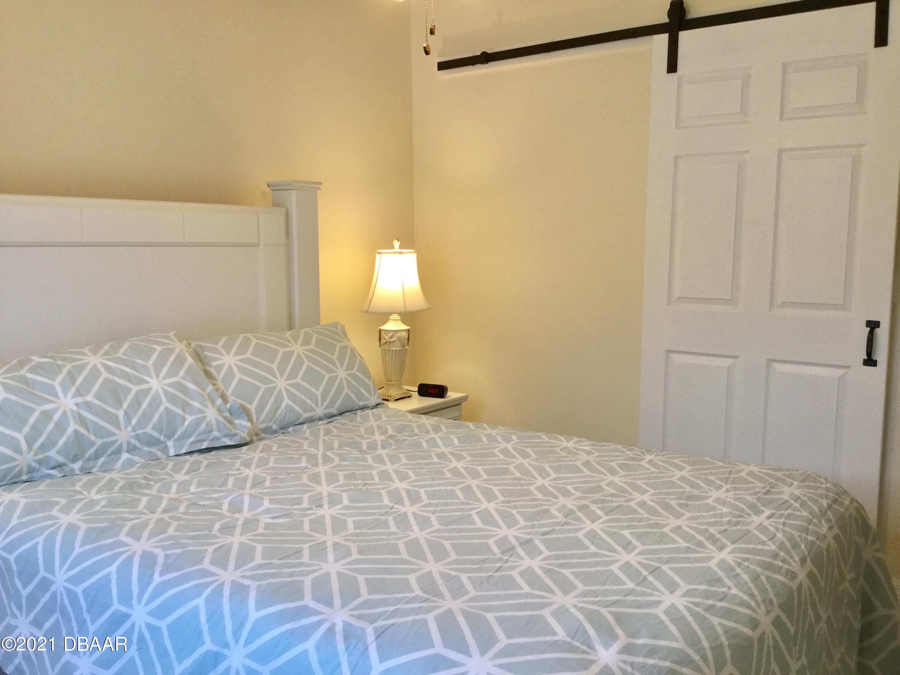 40 Riverside Lane Palm Coast, FL 32164 - Photo 46 of 47 a bedroom with a bed and a shower
