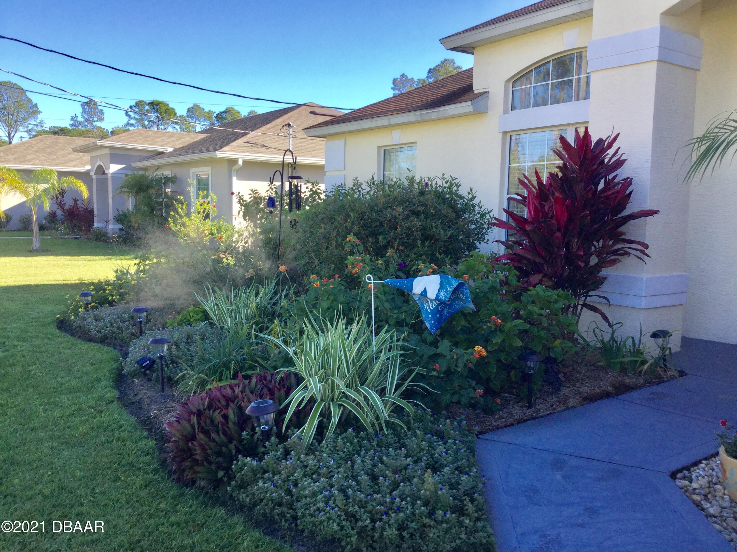 40 Riverside Lane Palm Coast, FL 32164 - Photo 5 of 47 a front view of a house with garden