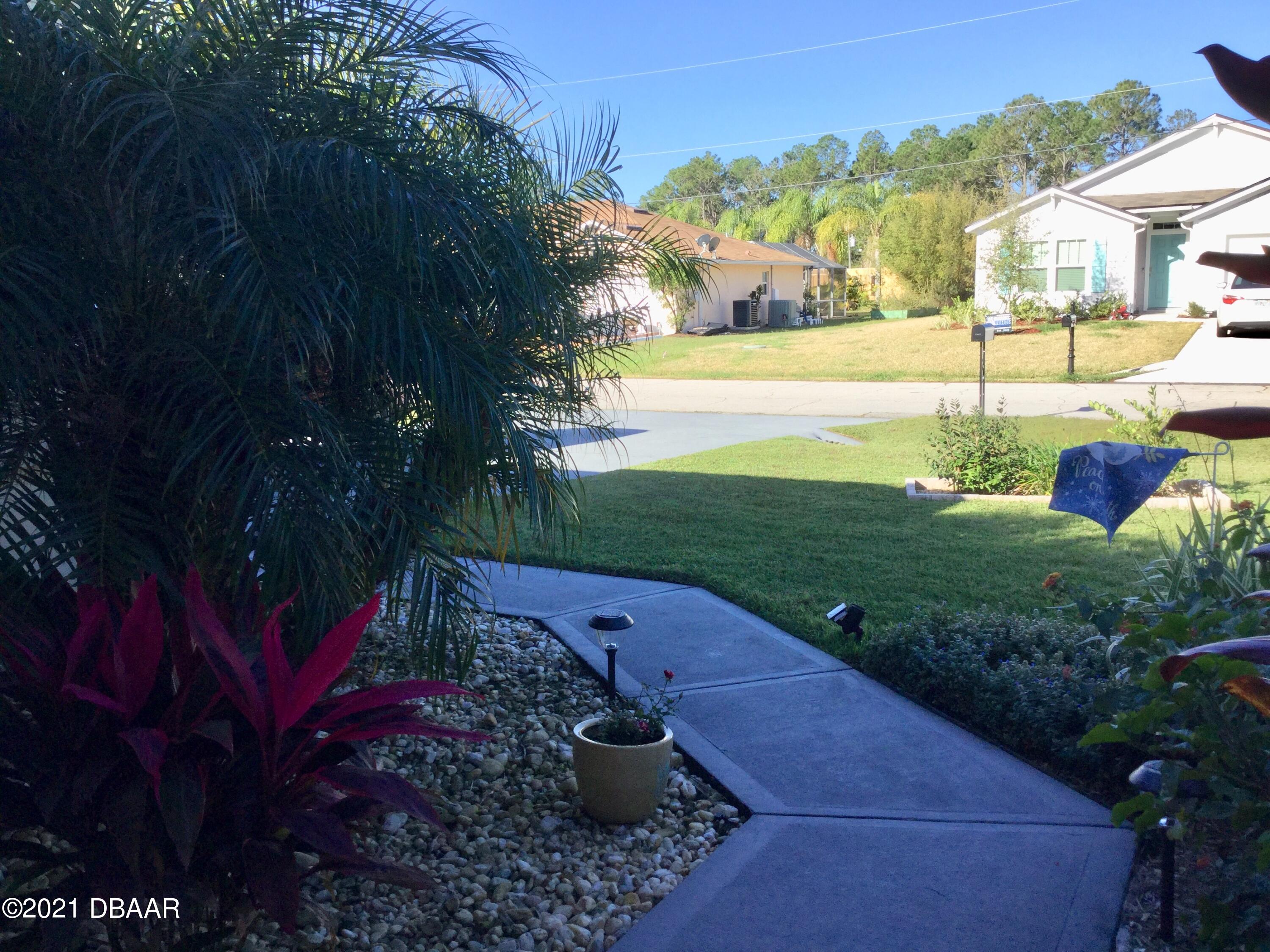 40 Riverside Lane Palm Coast, FL 32164 - Photo 6 of 47 a view of a street with a bench