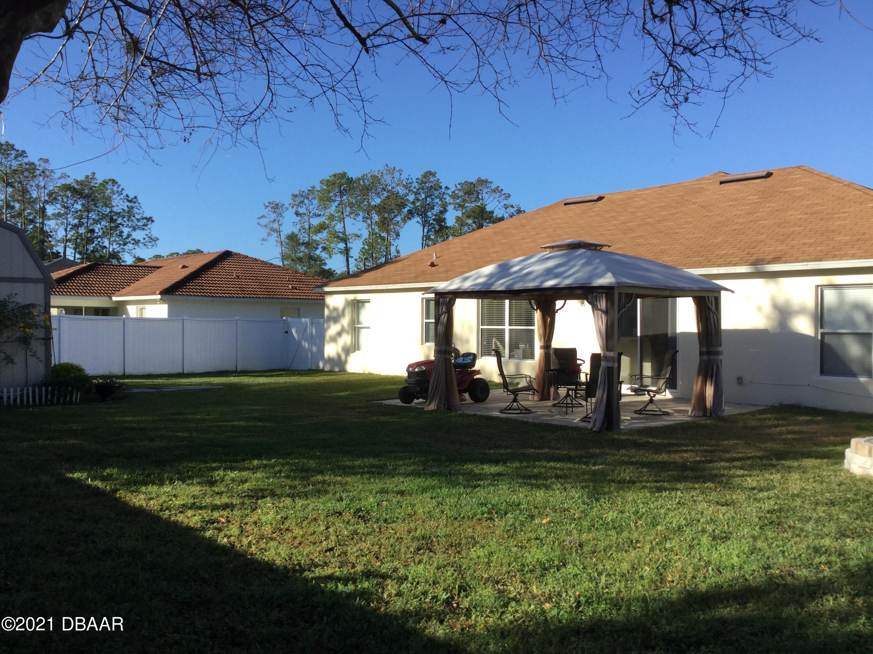 40 Riverside Lane Palm Coast, FL 32164 - Photo 7 of 47 a front view of a house with garden