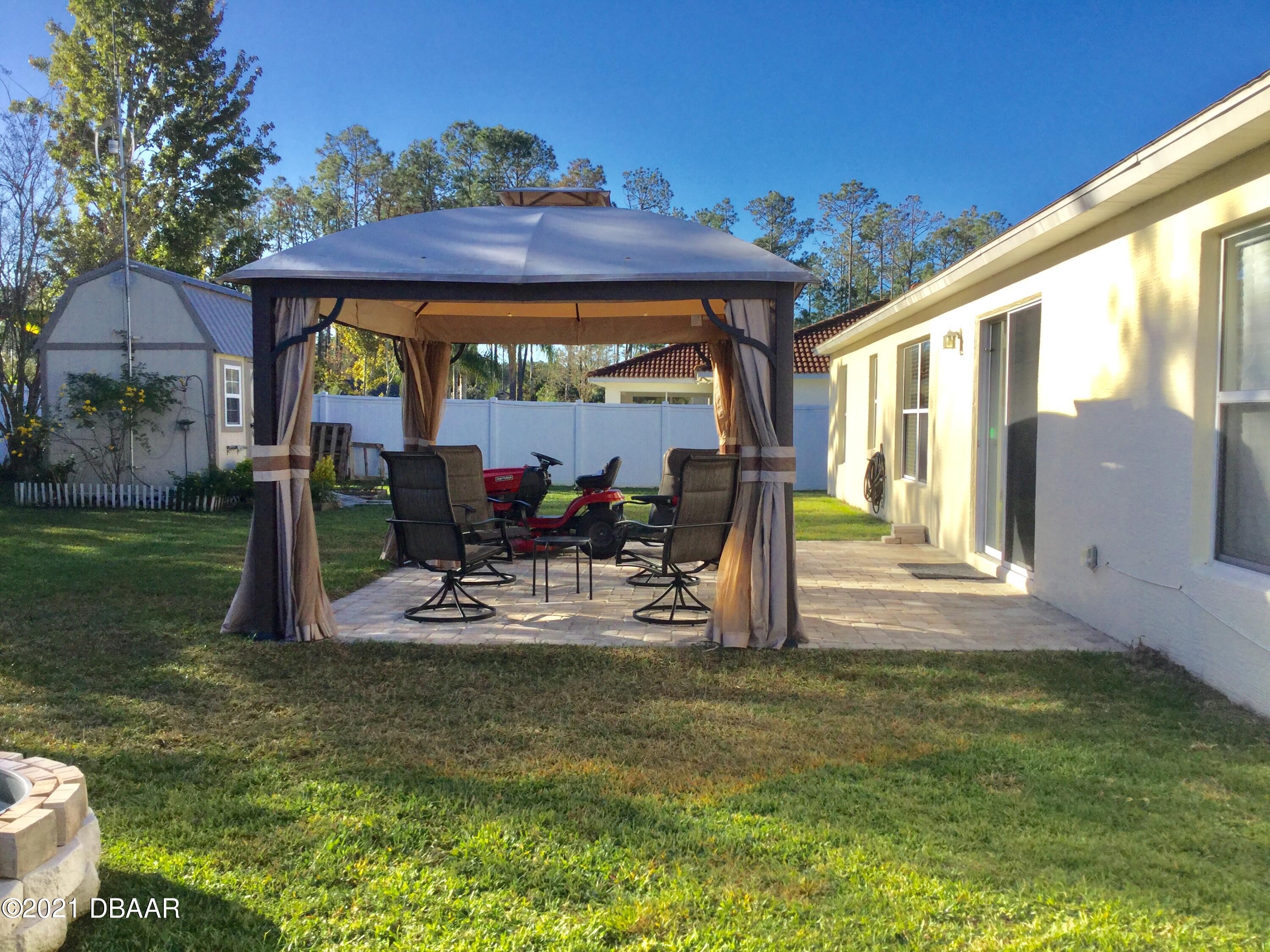 40 Riverside Lane Palm Coast, FL 32164 - Photo 8 of 47 a view of a house with backyard porch and sitting area