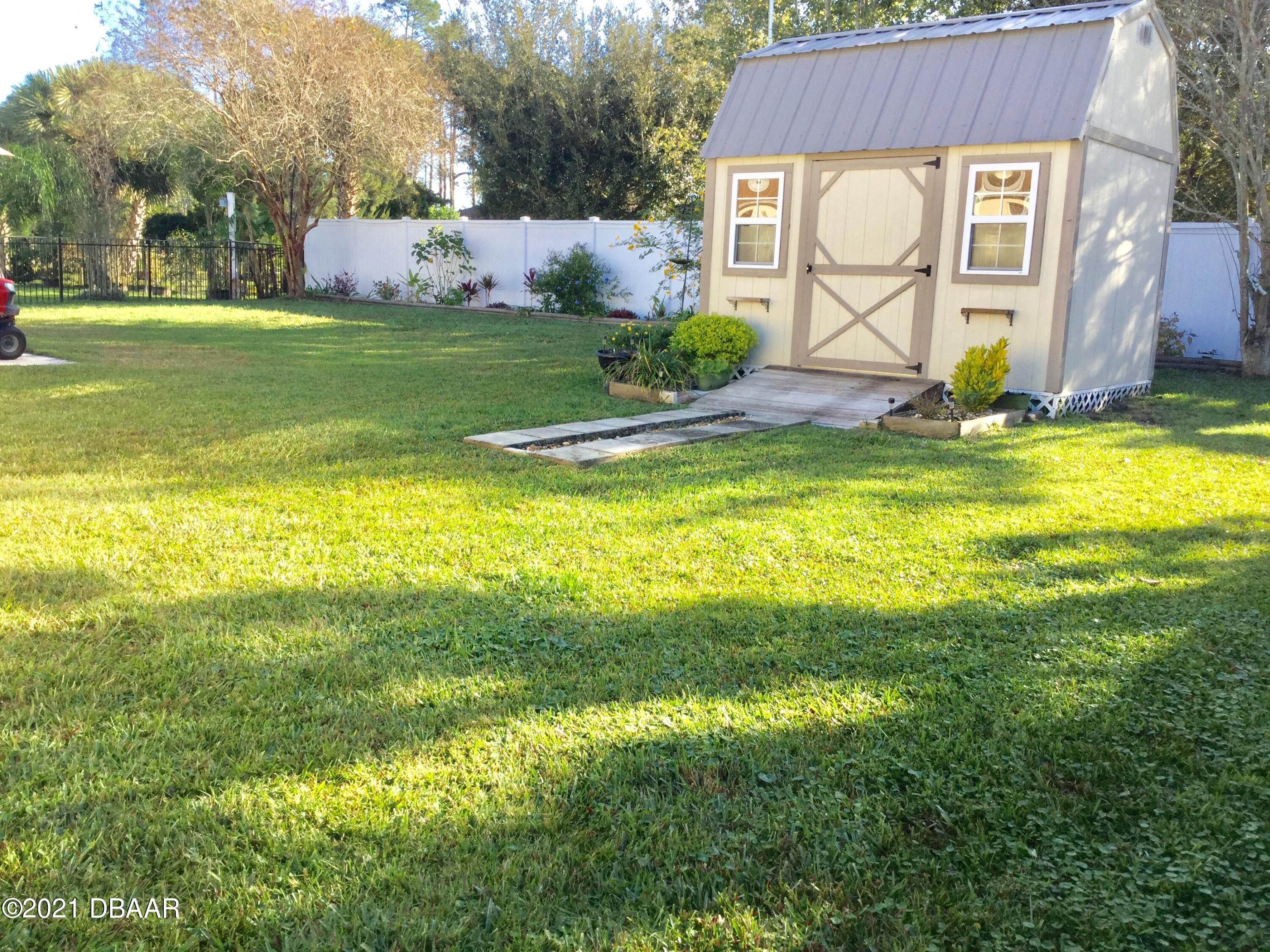 40 Riverside Lane Palm Coast, FL 32164 - Photo 10 of 47 a front view of house with yard and seating area