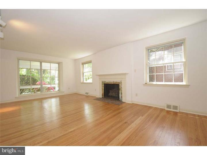 237 Hamilton Road Merion Station, PA 19066 - Photo 2 of 17 a view of empty room with wooden floor and fireplace