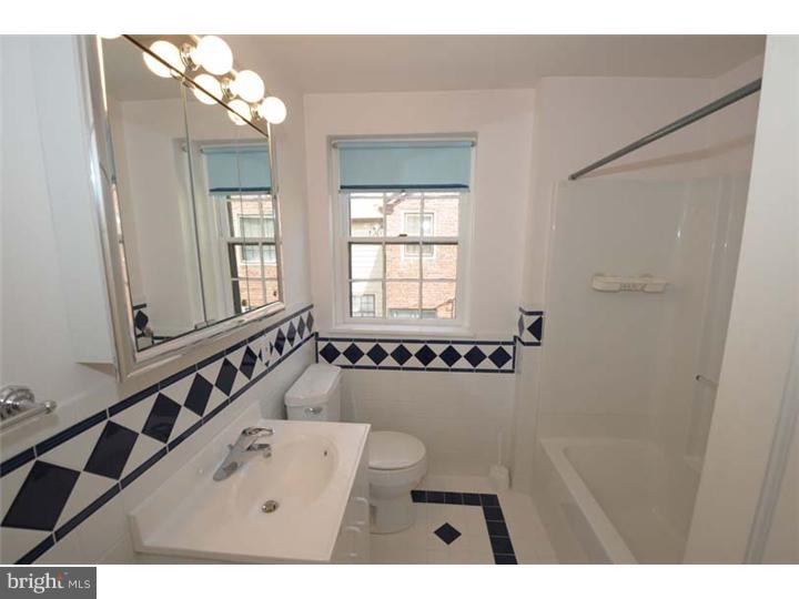 237 Hamilton Road Merion Station, PA 19066 - Photo 10 of 17 a bathroom with a bathtub a shower a sink and a window