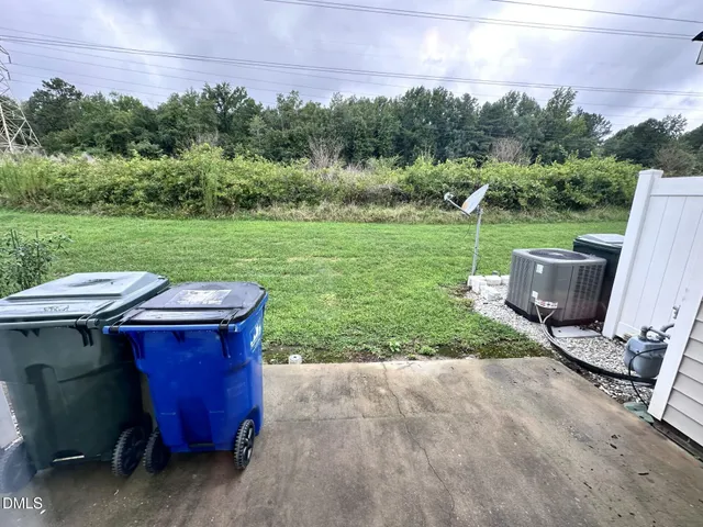 a view of backyard with outdoor seating and green space