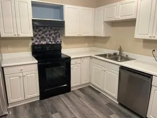 a kitchen with a sink stove and cabinets