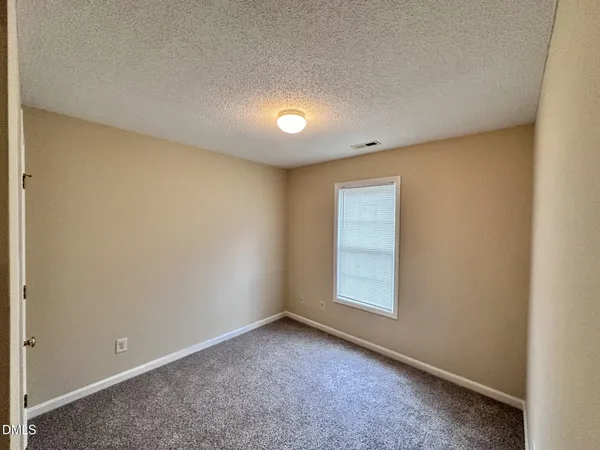 an empty room with a empty space and windows