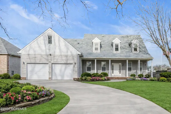 a front view of a house with a big yard