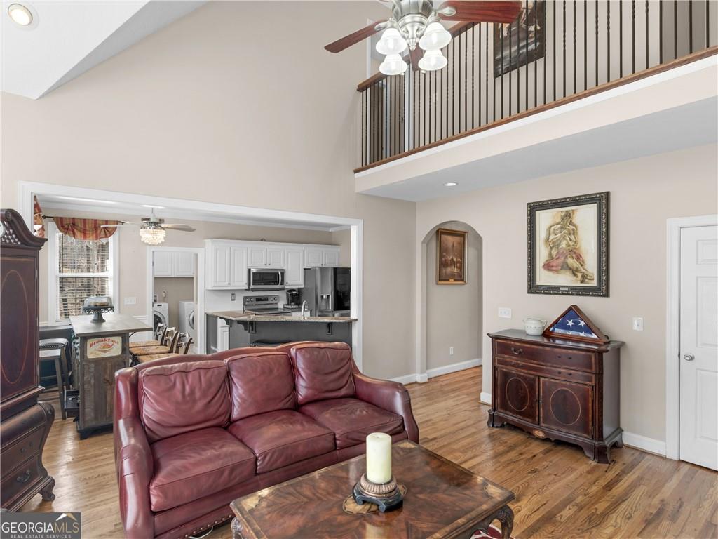 355 Parker Road Covington, GA 30014 - Photo 29 of 60 a living room with furniture and a wooden floor