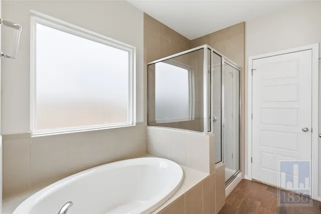 a bathroom with a bathtub and a shower