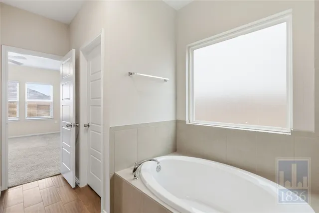 a white bath tub sitting next to a shower