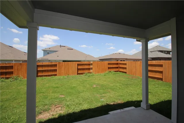 a backyard of a house with yard and outdoor seating